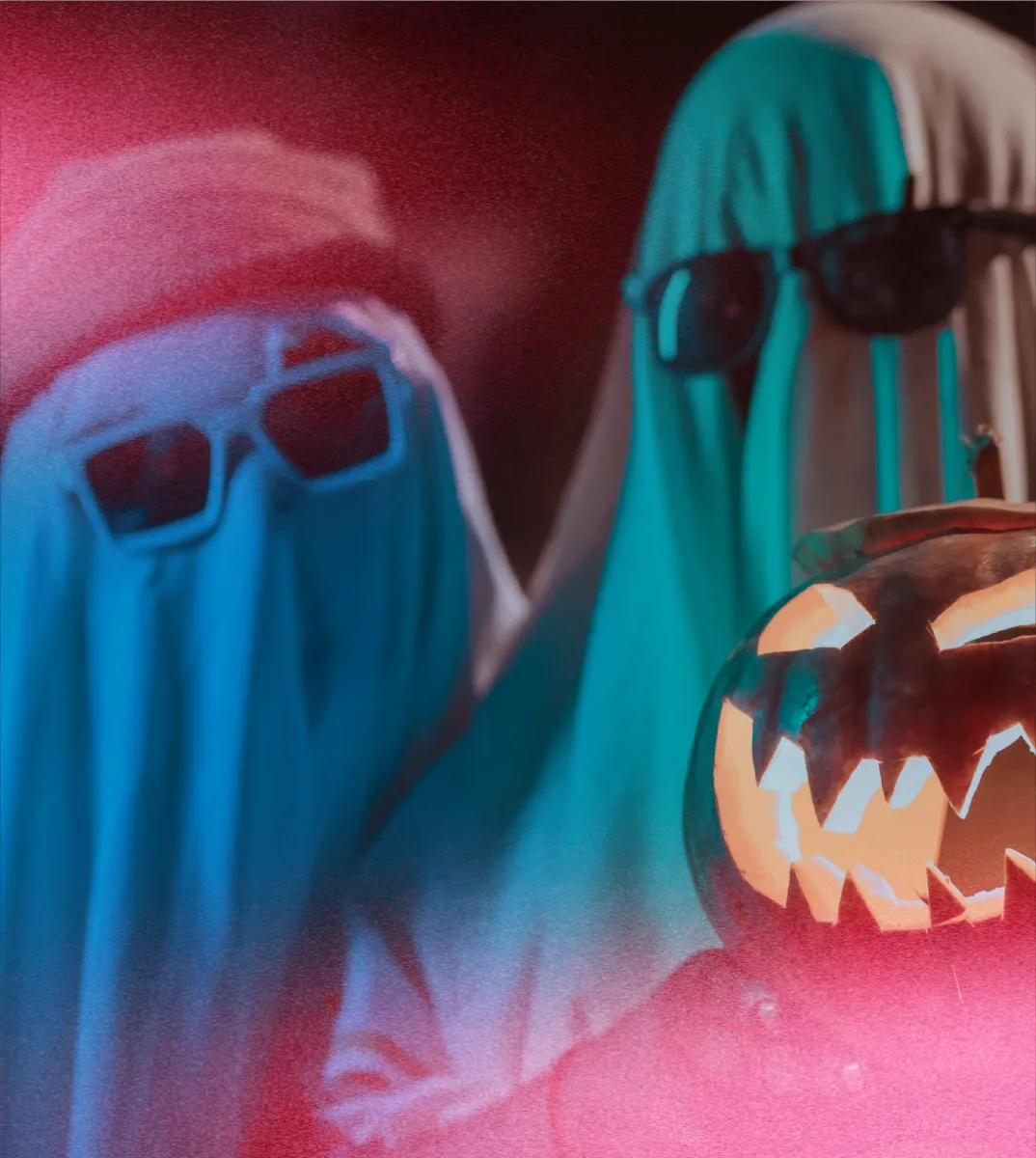 Two people in sheet-ghost costumes wearing sunglasses
