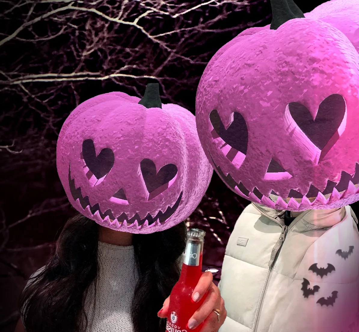Two friends in pink carved pumpkin heads at night, one holding up a Vodka Cruiser
